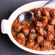 a white bowl filled with meatballs and sauce