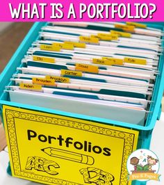 a blue plastic container filled with folders on top of a white table next to a pink and yellow sign that says what is a portfolio?