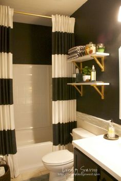 a bathroom with black and white striped curtains