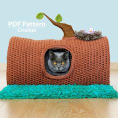 a cat in a knitted bed made to look like a carrot