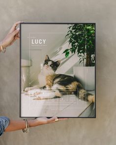 a person holding up a poster with a cat on it's side and the words lucky in front of them