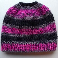 a knitted hat with pink, grey and black stripes