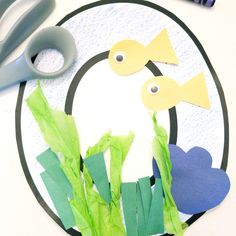 a paper plate with scissors and some cut outs on top of it that have been made to look like a duck