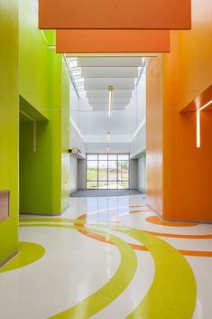 an empty hallway with colorful walls and flooring