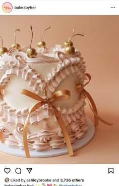 the cake is decorated with ruffles and gold decorations on it's sides