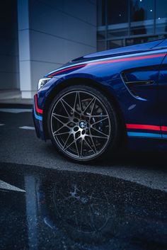 the front end of a blue car with red, white and blue stripes