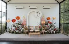 an outdoor ceremony setup with flowers and chairs