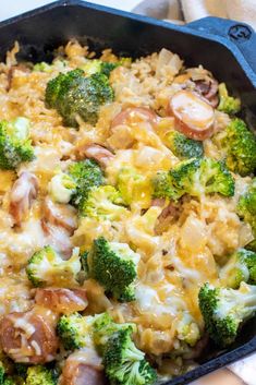 cheesy kielbasa broccoli and rice in a cast iron skillet