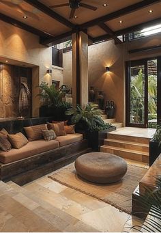 a living room filled with lots of furniture and plants on top of wooden flooring