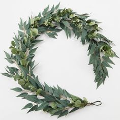 a wreath made out of green leaves and greenery