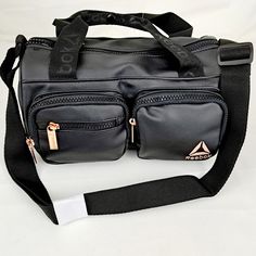 Reebok Matilda Duffle Unisex, Black With Rose Goldtone Hardware, Lightweight, Water Resistant, Adjustable Shoulder Strap, Purse, Bag Perfect For Sunmer, Gym, Sports Features: Dual Carry Straps, Shoulder Strap, 2 Front Outside Zip Pockets, Water Resistant, Top Zipper Across Inner Compartment. Small Duffle Bag, Waterproof Tote, Gym Tote, White Crossbody Bag, Strap Purse, Quilted Crossbody Bag, Lightweight Bag, Reebok Women, Womens Reebok