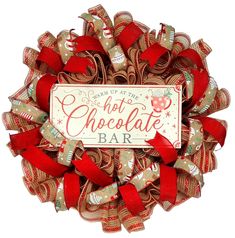 a christmas wreath with red bows and a sign that says hot chocolate bar on it