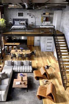 an overhead view of a living room with couches, tables and stairs in it