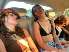 two women sitting in the back seat of a car