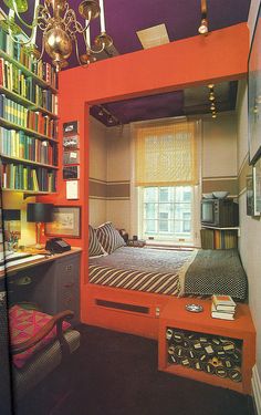 the room is decorated in bright colors and has bookshelves