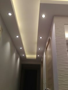 an image of a hallway with lights on the ceiling