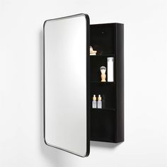 the medicine cabinet is black and has three shelves