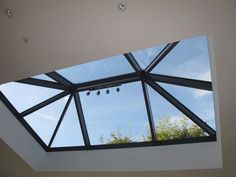 an open skylight in a room with white walls