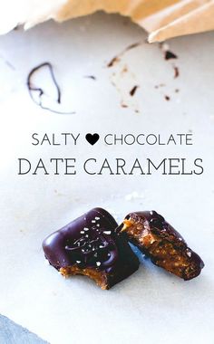 two pieces of chocolate date caramels on top of parchment paper with the words salty chocolate date caramels