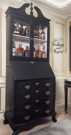 an old dresser with glass doors and gold trimmings is shown in this room