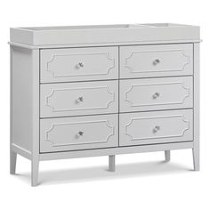 a white dresser with six drawers and two handles