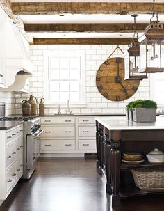 a kitchen with white cabinets and wooden floors