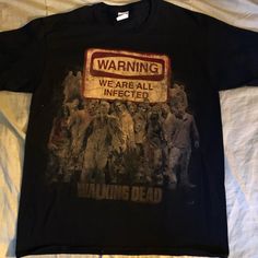 a black shirt with the walking dead on it