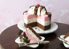 three pieces of cake sitting on top of white plates with chocolate and pink frosting