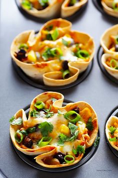 several plates filled with taco shells covered in sauce and toppings on top of each other