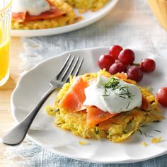 two white plates with food on them, one has eggs and the other has fruit