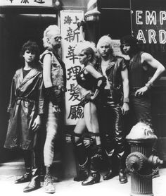 an old black and white photo of four women standing in front of a sign that says empire records