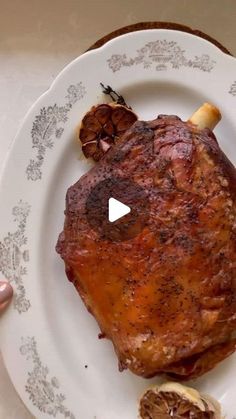 a piece of meat sitting on top of a white plate