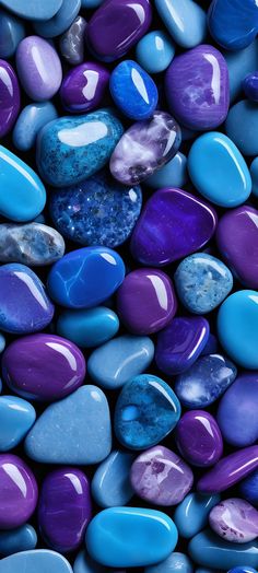 many different colored rocks are arranged in a pattern on top of each other, including blue and purple