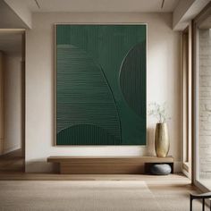 a large green painting hanging on the wall in a living room next to a window