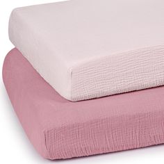 two pink and white sheets stacked on top of each other in front of a white background