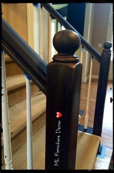 a wooden stair railing with writing on it