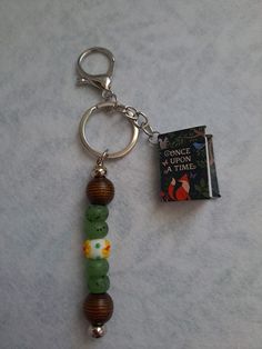 a key chain with beads and a book