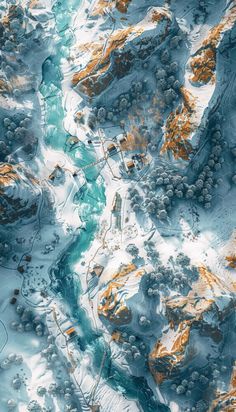 an aerial view of snow covered mountains and rivers