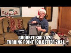 a man sitting on top of a couch next to a christmas hat and an amp