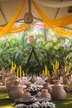 an outdoor setting with vases and candles