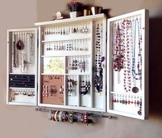 a white cabinet filled with lots of jewelry