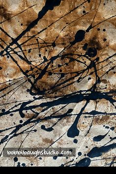 an abstract painting with black and brown paint