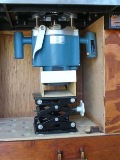 a blue and white machine sitting on top of a wooden box