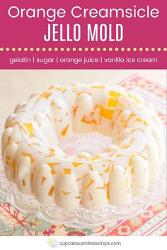 an orange creamsice jello mold on a glass cake plate with text overlay