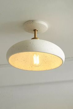 a white light fixture hanging from the ceiling