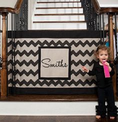 a black and white chevroned rug with the name suitee on it in front of some banisters