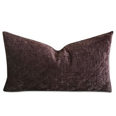 a dark purple velvet pillow on a white background