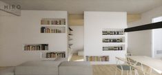 a living room filled with furniture and bookshelves next to a dining room table