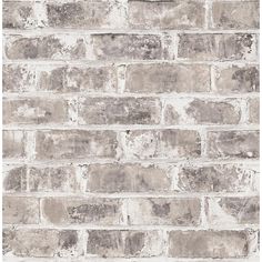 a white brick wall with grey bricks on it