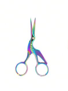 a pair of colorful scissors sitting next to each other on a white surface with one cut in half